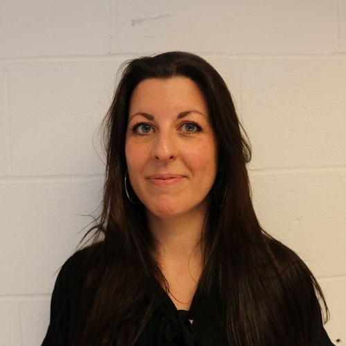 Headshot photo of Jill Keegan, a white woman with long dark brown hair.